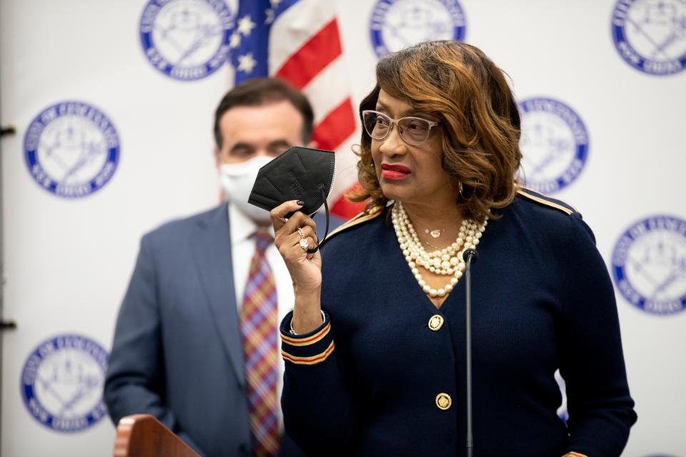 City Health Commissioner Melba Moore holds up a mask while urging people to wear them during a press conference updating the COVID-19 pandemic ahead of the holidays on Tuesday, Dec. 21, 2021, in Cincinnati.