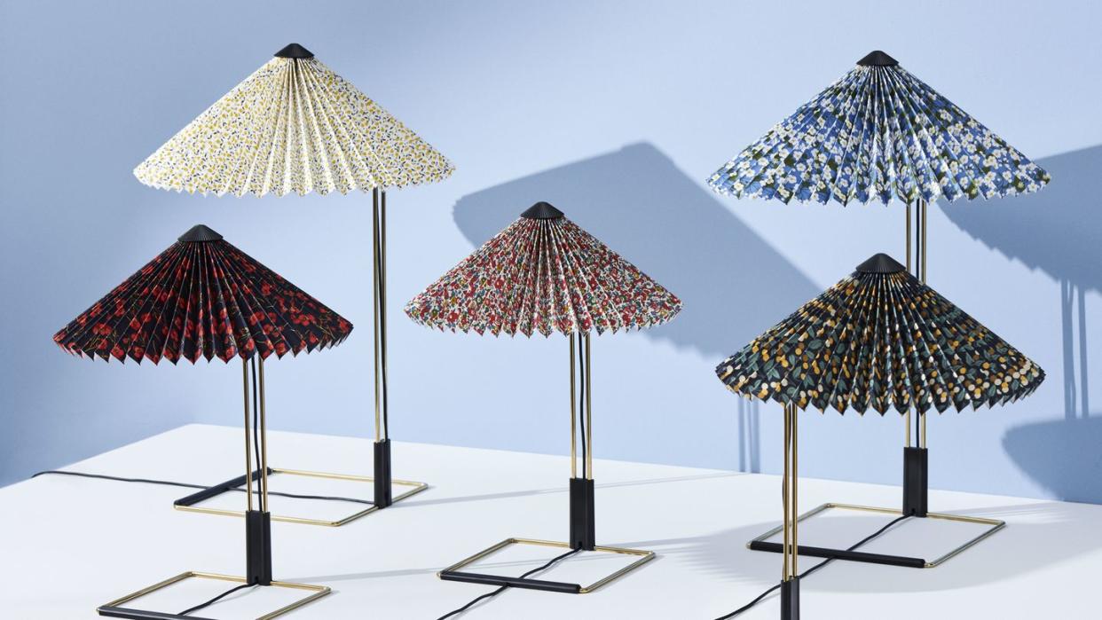 a series of hay lamps with colorful pleated shades featuring liberty fabrics