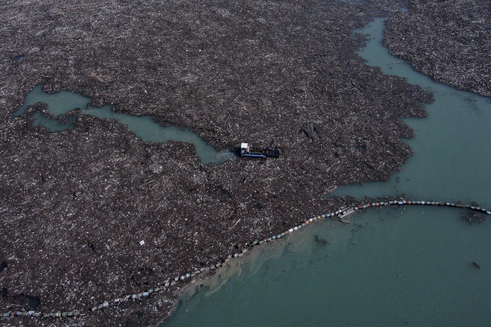 This aerial photo shows garbage floating in the Drina river near Visegrad, eastern Bosnia, Wednesday, Feb. 24, 2021. Environmental activists in Bosnia are warning that tons of garbage floating down the Balkan country's rivers are endangering the local ecosystem and people's health. The Drina River has been covered for weeks with trash that has piled up faster than the authorities can clear it out. (AP Photo/Kemal Softic)