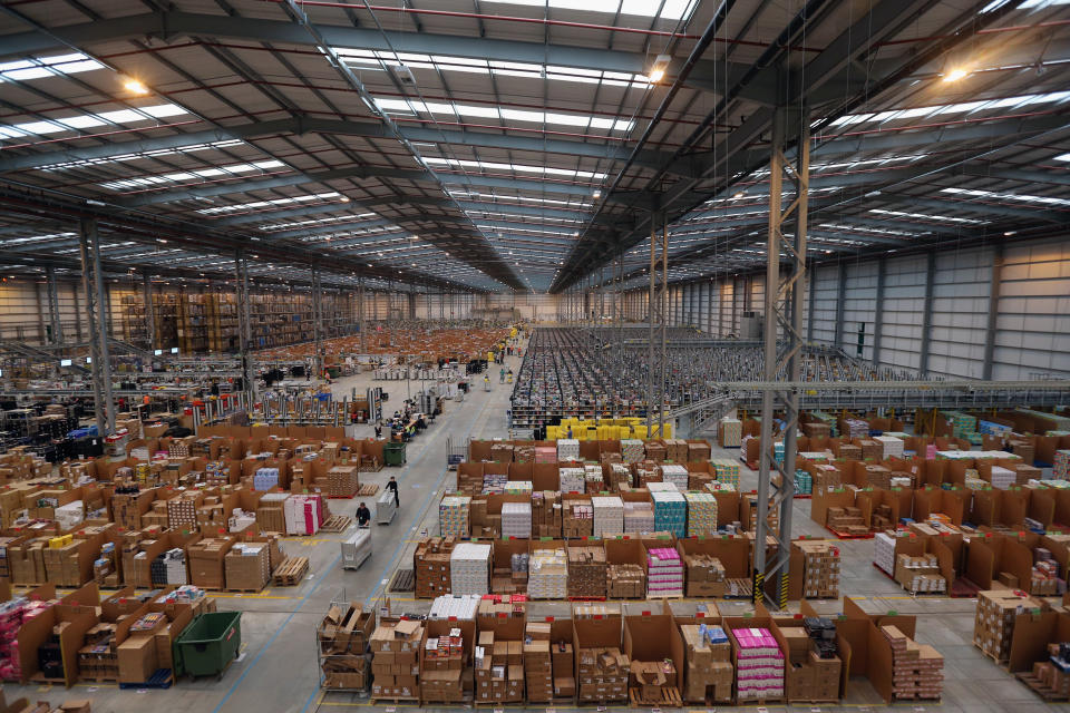 PETERBOROUGH, ENGLAND - NOVEMBER 28:  Employees select and dispatch items in the huge Amazon 'fulfilment centre' warehouse on November 28, 2013 in Peterborough, England. The online retailer is preparing for 'Cyber Monday', as it predicts the busiest day for online shopping in the UK will fall on Monday December 2nd this year. On Cyber Monday in 2012 amazon.co.uk recorded over 3.5 million individual items ordered, which equates to 41 items purchased per second. The Peterborough fulfilment centre is 500,000 sq ft, equivalent to approximately seven football pitches in floor area. Amazon are due to employ more than 1,000 seasonal staff to cope with increased demand in the run up to Christmas.  (Photo by Oli Scarff/Getty Images)