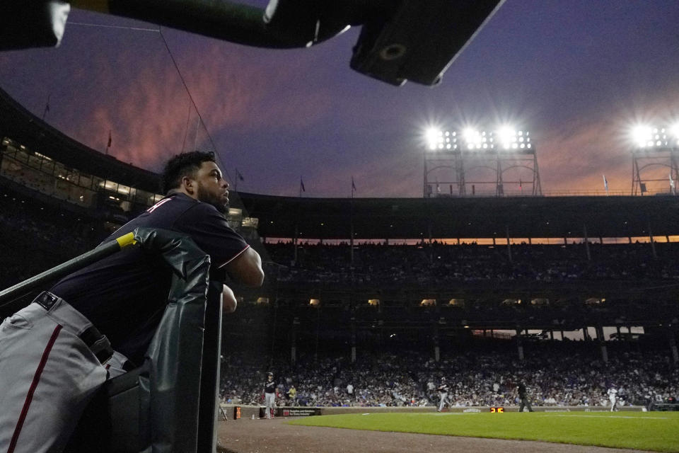Washington Nationals' Luis Garcia watches teammates on the field as the sun sets in the West during the fifth inning of a baseball game against the Chicago Cubs in Chicago, Wednesday, July 19, 2023. (AP Photo/Nam Y. Huh)