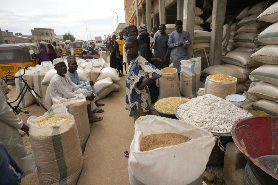 People sell grain at Dawanau International Market in Kano Nigeria, Friday, July 14, 2023. Nigeria introduced programs before and during Russia's war in Ukraine to make Africa's largest economy self-reliant in wheat production. But climate fallout and insecurity in the northern part of the country where grains are largely grown has hindered the effort. (AP Photo/Sunday Alamba)