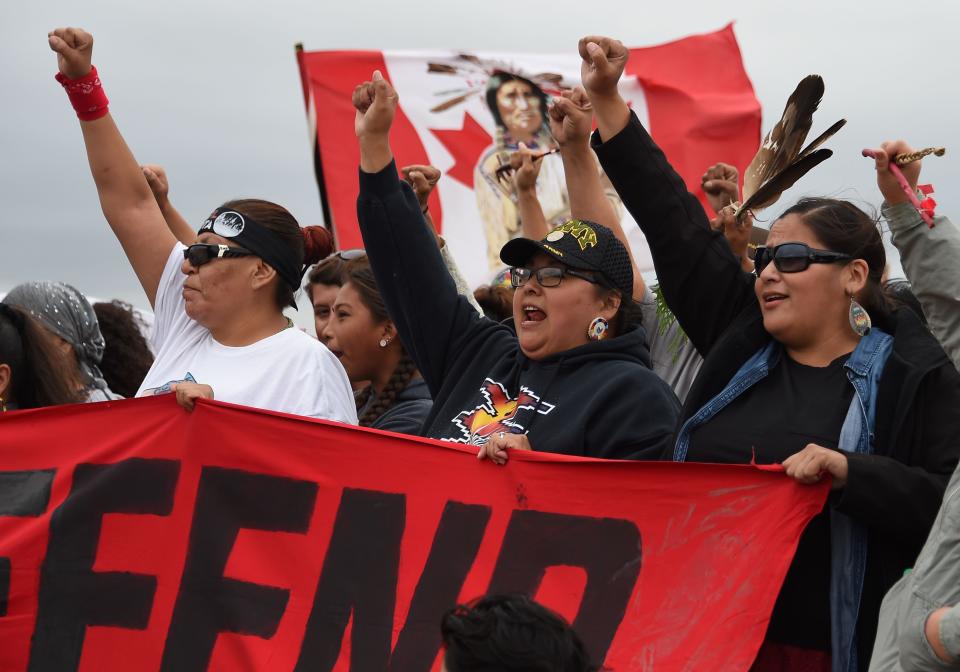 Native Americans march to a sacred burial ground that was disturbed by bulldozers building the Dakota Access Pipeline (DAPL), near the encampment where hundreds of people have gathered to join the Standing Rock Sioux Tribe's protest of the oil pipeline slated to cross the nearby Missouri River, September 4, 2016 near Cannon Ball, North Dakota.