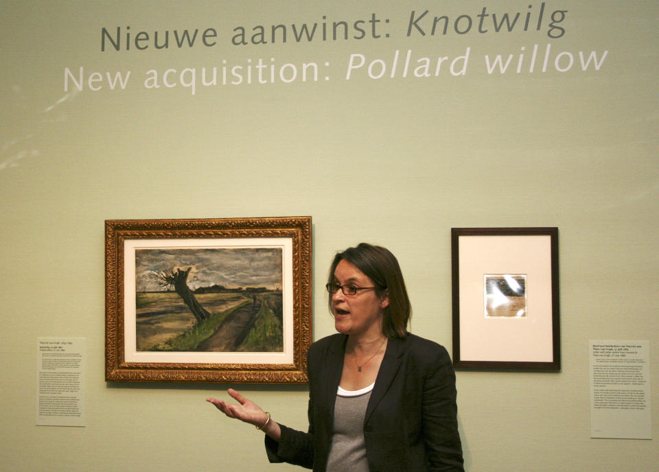 Marije Vellekoop, the museum's curator of prints and drawings, speaks near an 1882 water color of a pollard willow by Vincent van Gogh at the Van Gogh Museum in Amsterdam, Netherlands, Thursday May 10, 2012. The Van Gogh Museum unveiled the painting Thursday, the first addition in five years to its world-famous collection of works by the post-impressionist.  (AP Photo/Mike Corder)