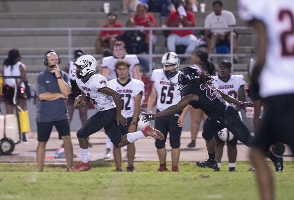 Marquez Jones (4) gets past the last Raider defender on his way to a touchdown and a 26-12 Jaguars lead during the West Florida vs Navarre preseason football game at Navarre High School on Friday, Aug. 18, 2023.