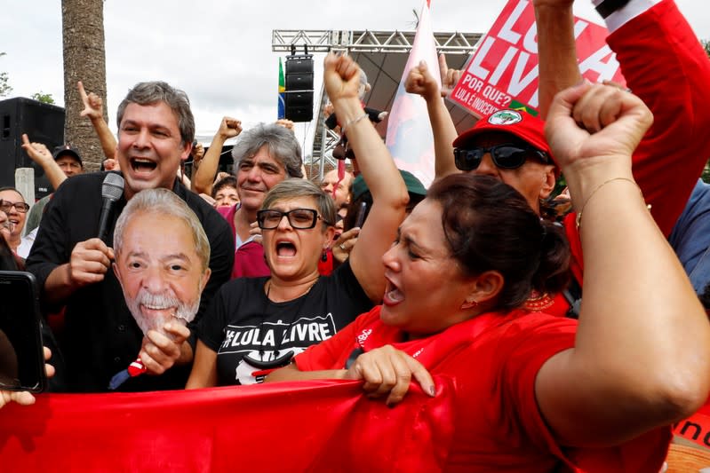 Supporters of Brazil's former President Luiz Inacio Lula da Silva gesture outside the Federal Police headquarters where Lula is serving a prison sentence, in Curitiba