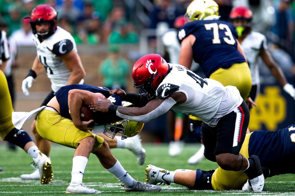 Cincinnati Bearcats defensive lineman Malik Vann (42) sacks Notre Dame Fighting Irish quarterback Drew Pyne (10) in the second half of the NCAA football game on Saturday, Oct. 2, 2021, at Notre Dame Stadium. Vann played just two games in 2022 due to injury and is returning to the Bearcats for another season.