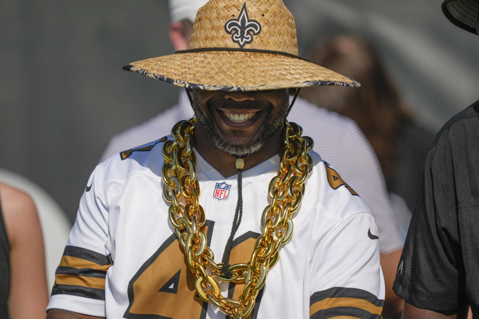 A Saints fan smiles as he waits for practice during the Back Together Weekend fan appreciation initiative at the NFL team's football training camp in Metairie, La., Saturday, July 29, 2023. (AP Photo/Gerald Herbert)