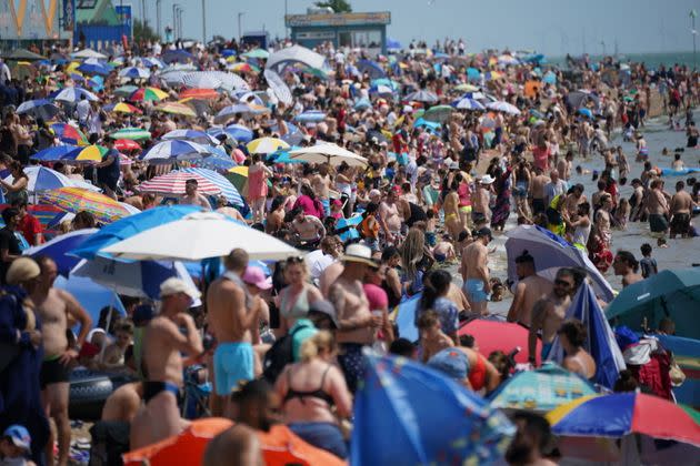 People relax on the beach at Southend-on-Sea on the Thames Estuary in Essex. Temperatures are predicted to hit 31C across central England on Sunday ahead of record-breaking highs next week. Picture date: Sunday July 17, 2022. (Photo: Yui Mok via PA Wire/PA Images)