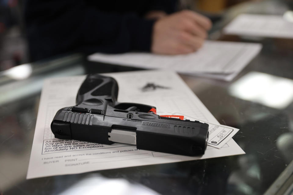 Image: A customer purchases a gun at Freddie Bear Sports on April 8, 2021 in Tinley Park, Illinois. (Scott Olson / Getty Images)