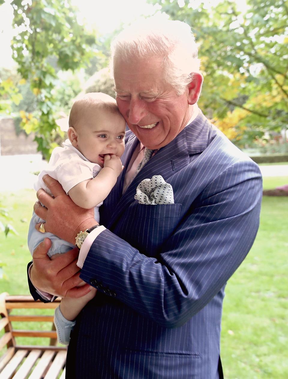 Prince Charles holds Prince Louis