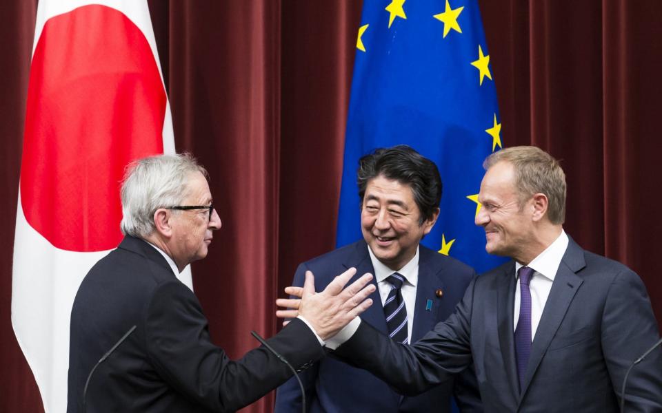 Shinzo Abe, Japan's prime minister, with Jean-Claude Juncker (left) and Donald Tusk.  - Bloomberg
