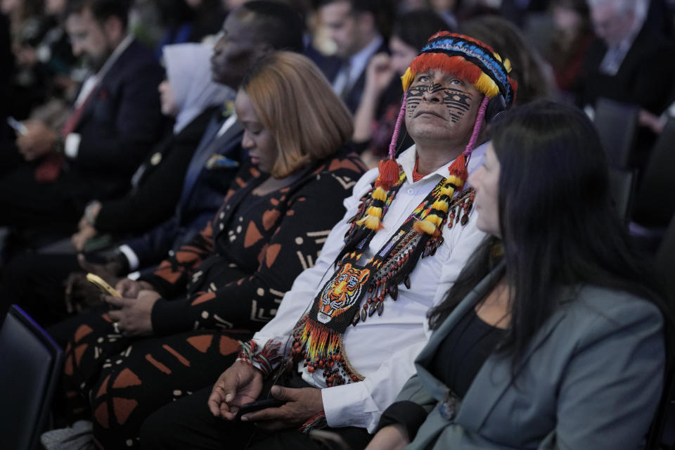 Uyunkar Domingo Peas Nampichkai, a chief of a tribe from Ecuador, listens to a panel discussion on the climate changes at the Annual Meeting of World Economic Forum in Davos, Switzerland, Wednesday, Jan. 17, 2024. The annual meeting of the World Economic Forum is taking place in Davos from Jan. 15 until Jan. 19, 2024.(AP Photo/Markus Schreiber)