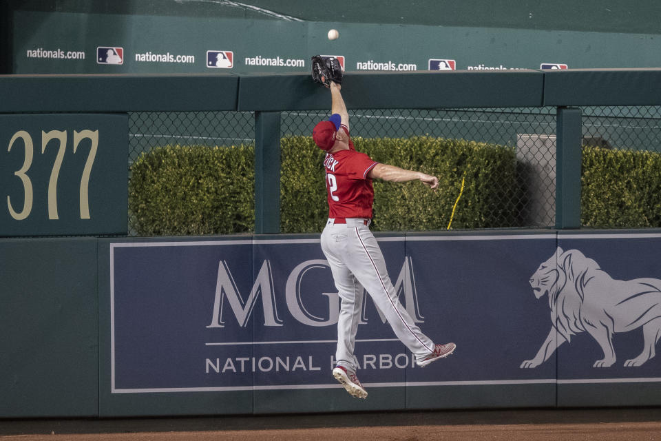 Philadelphia Phillies left fielder Kyle Garlick can't catch a solo home run by Washington Nationals' Jake Noll during the ninth inning of an exhibition baseball game at Nationals Park, Saturday, July 18, 2020, in Washington. The Phillies won 7-2. (AP Photo/Alex Brandon)