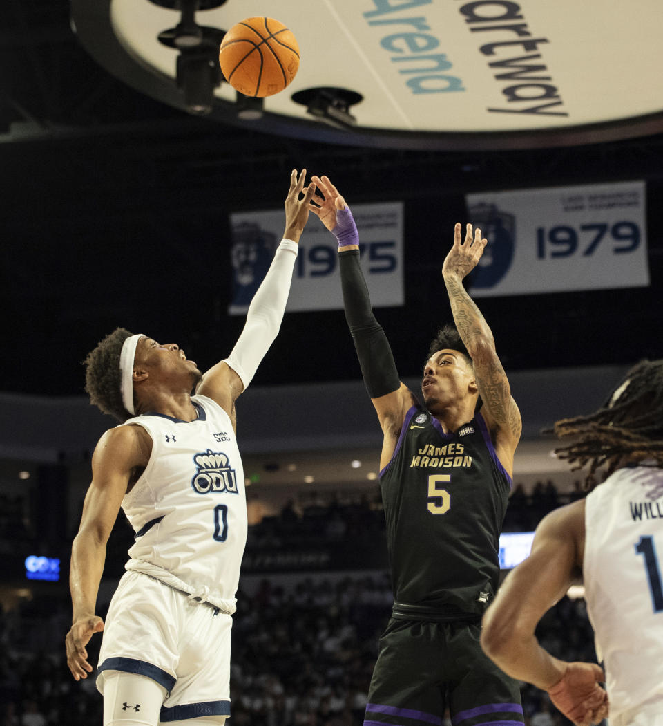 James Madison guard Terrence Edwards (5) attempts a shot over Old Dominion guard Vasean Allette (0) during the first half of an NCAA college basketball game Saturday, Dec. 9, 2023, in Norfolk, Va. (AP Photo/Mike Caudill).