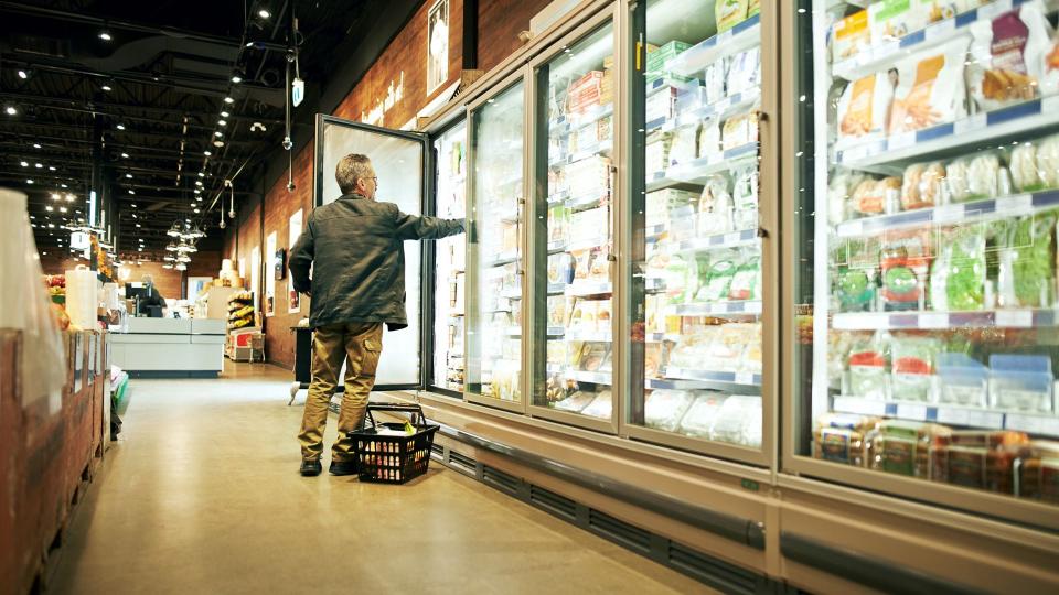 Shot of a mature man shopping in the cold produce section of a supermarket.