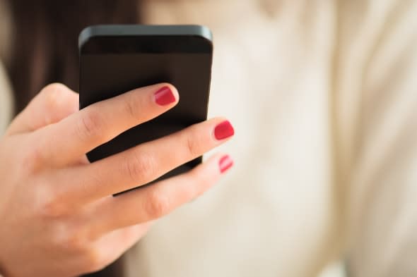 Close-up Of Woman's Hand Using Cell Phone