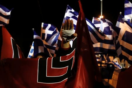 FILE PHOTO: A supporter of Greece's far-right Golden Dawn party salutes in a Nazi style during a rally at central Syntagma square in Athens