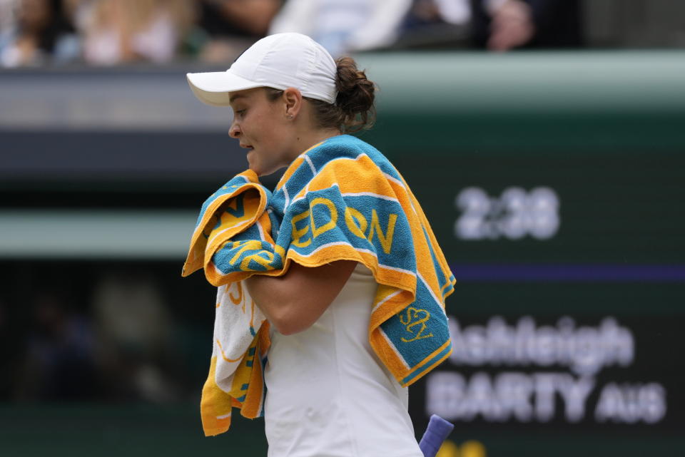 Australia's Ashleigh Barty walks back to her chair after losing a game to Germany's Angelique Kerber during the women's singles semifinals match on day ten of the Wimbledon Tennis Championships in London, Thursday, July 8, 2021. (AP Photo/Kirsty Wigglesworth)