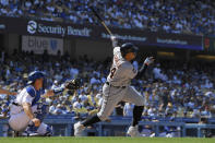Detroit Tigers' Miguel Cabrera, right, hits a two-run home run as Los Angeles Dodgers catcher Will Smith watches during the eighth inning of a baseball game Sunday, May 1, 2022, in Los Angeles. (AP Photo/Mark J. Terrill)
