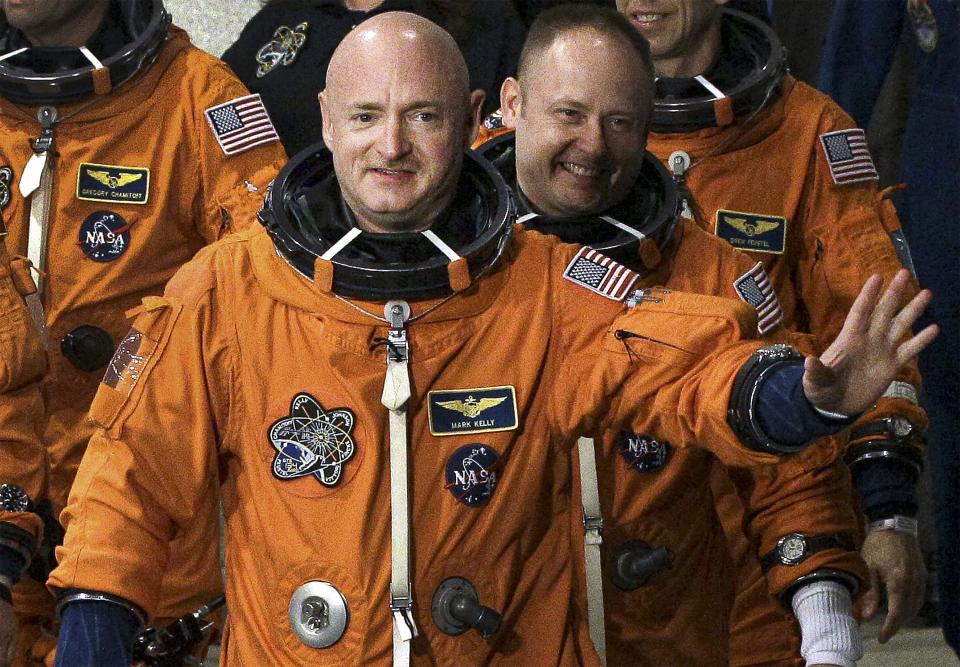 FILE - In this May 16, 2011, file photo, former NASA astronaut STS-134 commander Mark Kelly, front, waves a he leaves the Operations and Checkout Building with fellow crew members, including Mike Fincke, for a trip to Launch Pad 39-A, and a planned liftoff on the space shuttle Endeavour at Kennedy Space Center in Cape Canaveral, Fla. A Kelly victory would shrink the GOP's Senate majority at a crucial moment and complicate the path to confirmation for President Donald Trump's Supreme Court nominee. (AP Photo/Chris O'Meara, File)