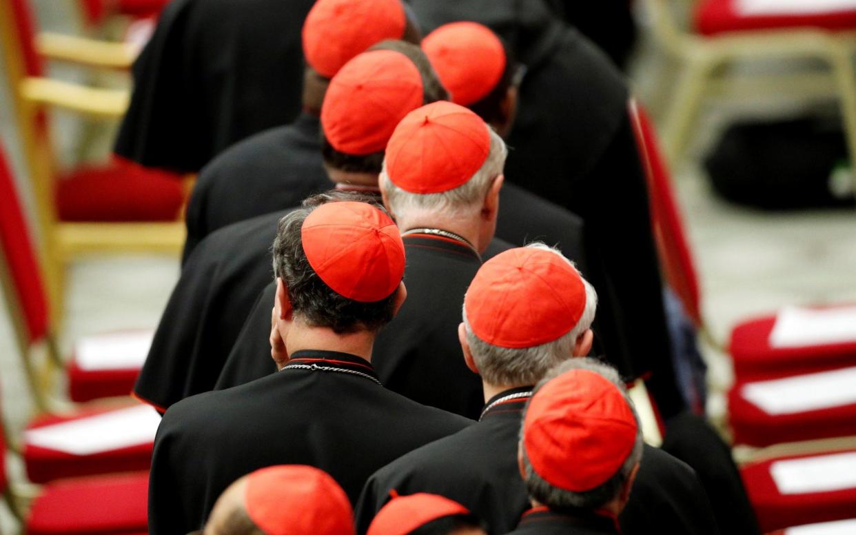 Cardinals wait for Pope Francis' arrival before his meeting with the youth and the Synod Fathers at the Paul VI Hall in Vatican - REUTERS