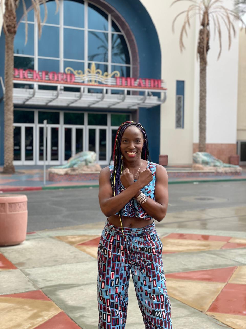 Cathedral City resident Janeshia Adams-Ginyard does the "Wakanda Forever" pose in front of the Mary Pickford Theater on Tuesday, Oct. 8, 2022.