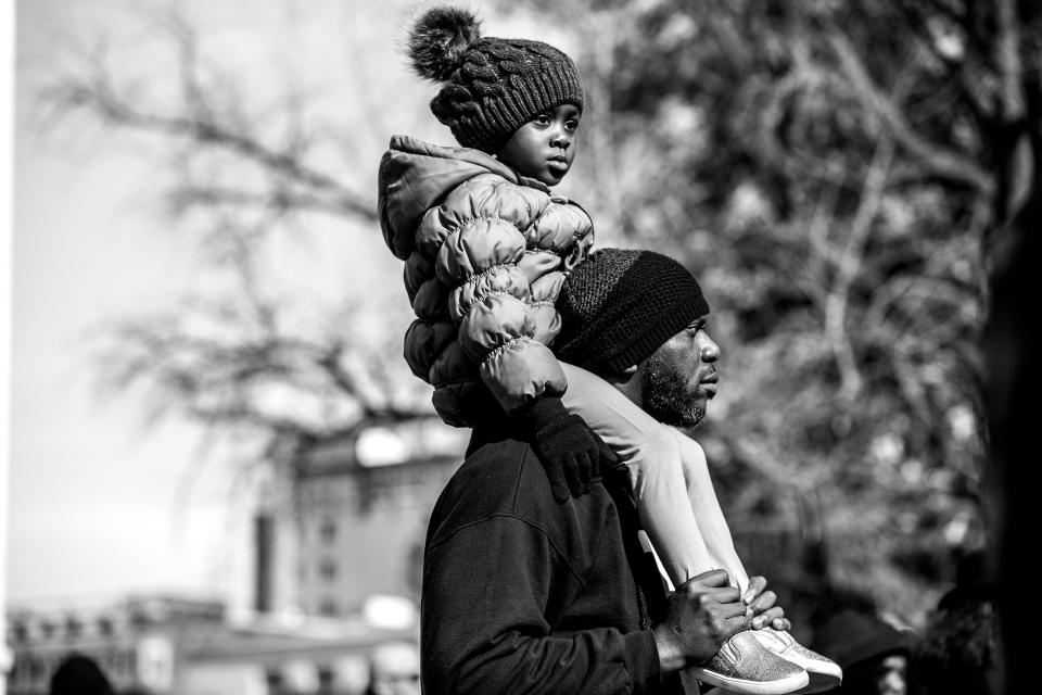 Lester Young, 47, and his daughter Kaleeyah, 4, listen to the 2020 Democratic candidates during the MLK Day celebration at the South Carolina Statehouse in Columbia, South Carolina. (Photo: )