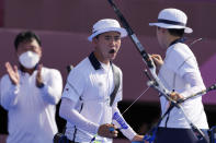 South Korea's Kim Je Deok celebrates with his teammate An San during the mixed team competition at the 2020 Summer Olympics, Saturday, July 24, 2021, in Tokyo, Japan. (AP Photo/Alessandra Tarantino)