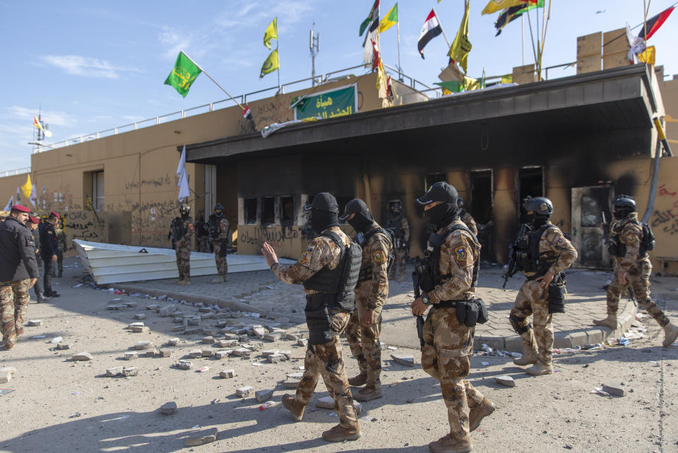 Iraqi army soldiers are deployed in front of the U.S. embassy, in Baghdad, Iraq, Wednesday, Jan. 1, 2020. Iran-backed militiamen have withdrawn from the U.S. Embassy compound in Baghdad after two days of clashes with American security forces. (AP Photo/Nasser Nasser)