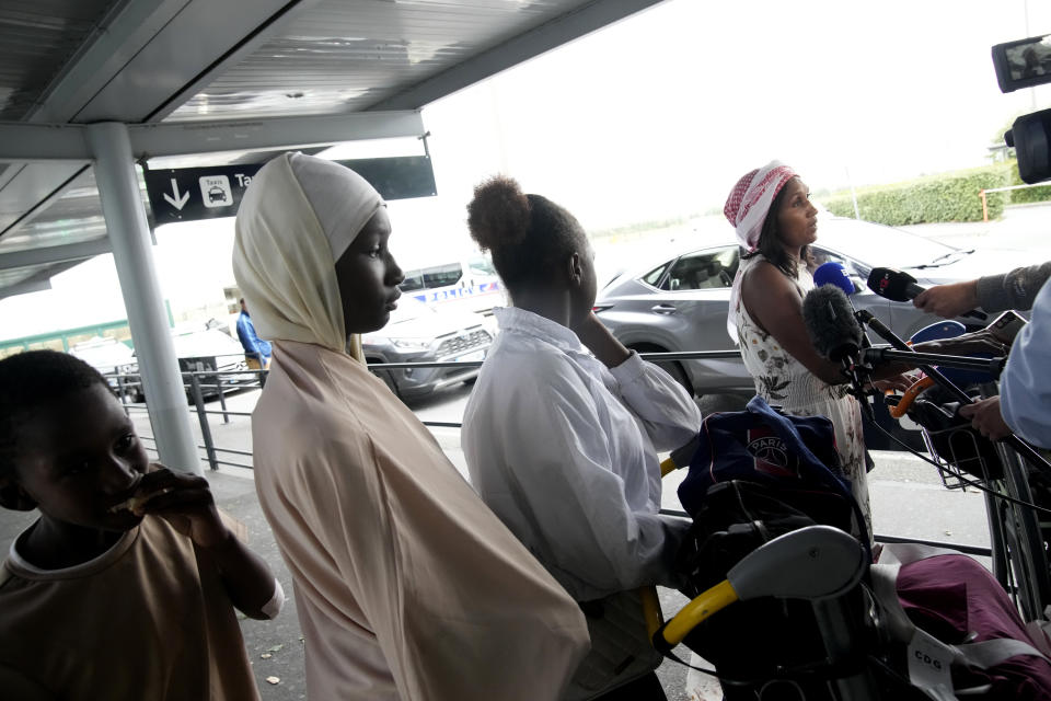 People evacuated from Niger speak to medias at the Roissy Charles de Gaulle airport, north of Paris, France, Wednesday, Aug. 2, 2023. European militaries are continuing to evacuate foreign nationals from Niger, with a third French military flight expected to depart the African nation's capital. Defense chiefs from West Africa's regional bloc are set to meet to discuss last week's coup against the country's democratically elected president. (AP Photo/Christophe Ena)