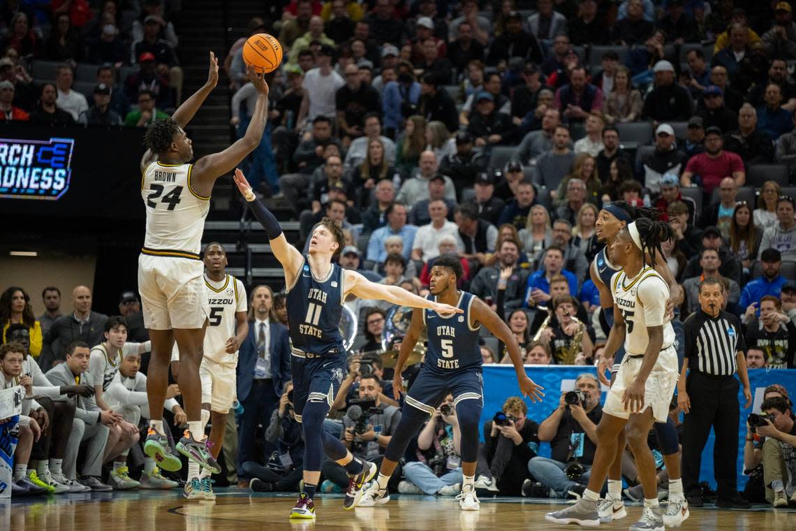 Missouri Tigers guard Kobe Brown (24) shoots a three-point basket over Utah State Aggies guard Max Shulga (11) during a game for the NCAA Tournament at Golden 1 Center in Sacramento, Thursday, March 16, 2023.