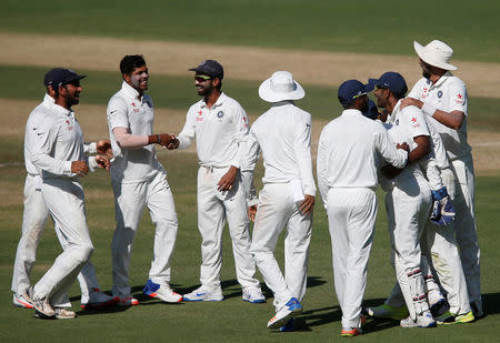Cricket - India v Australia - First Test cricket match - Maharashtra Cricket Association Stadium, Pune, India - 23/02/17. India's Umesh Yadav celebrates with team mates the wicket of Australia's Steve O'Keefe. REUTERS/Danish Siddiqui