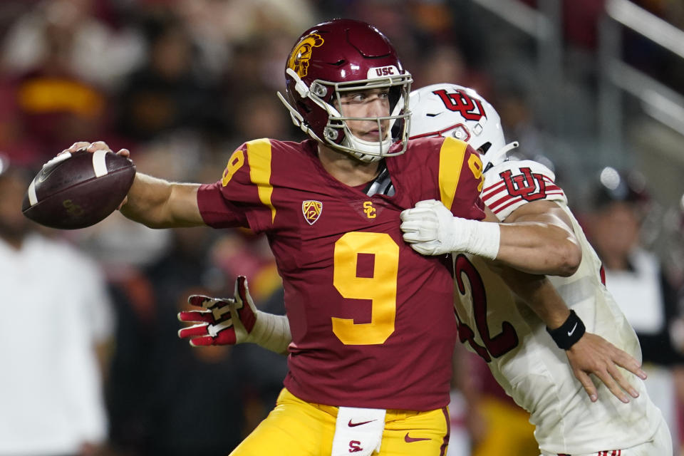 Southern California quarterback Kedon Slovis (9) throws under pressure from Utah defensive end Mika Tafua during the second half of an NCAA college football game Saturday, Oct. 9, 2021, in Los Angeles. (AP Photo/Marcio Jose Sanchez)