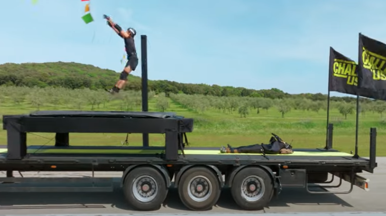 Competitors must jump on a trampoline — on a moving truck! — on The Challenge. (CBS)