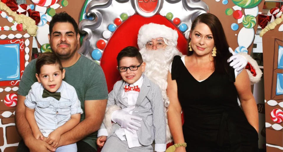 Naletta, Steven and two sons smile for Christmas photo with Santa