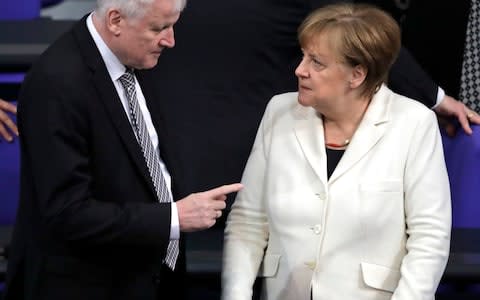 Horst Seehofer and Mrs Merkel in March - Credit: Markus Schreiber /AP