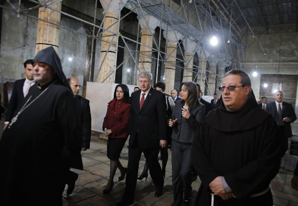 Canada's Prime Minister Harper is escorted by Bethlehem mayor Baboun and Palestinian minister of tourism and antiquities Ma'ayah during his visit to the Church of Nativity in Bethlehem