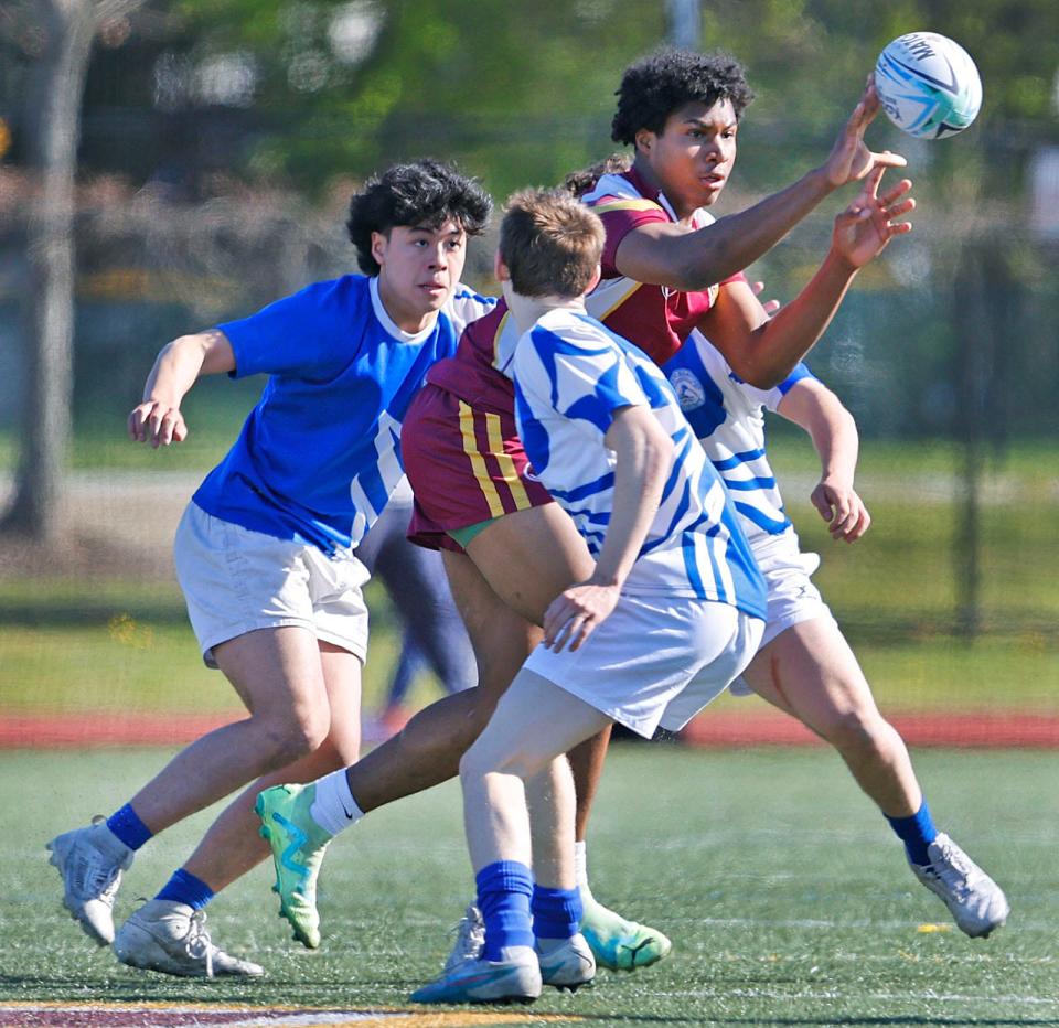 Wildcat Naheem Ridore gts off a pass under pressure. 

Weymouth hosts Braintree in boys rugby on Friday May 3, 2024