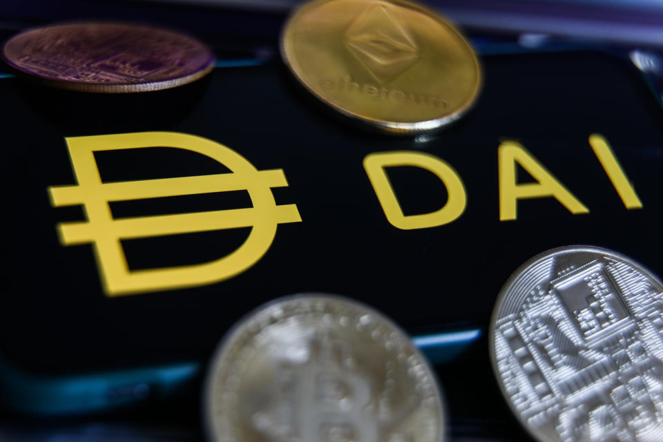 Dai logo displayed on a phone screen and representation of cryptocurrencies are seen in this illustration photo taken in Krakow, Poland on June 10, 2022. (Photo by Jakub Porzycki/NurPhoto via Getty Images)