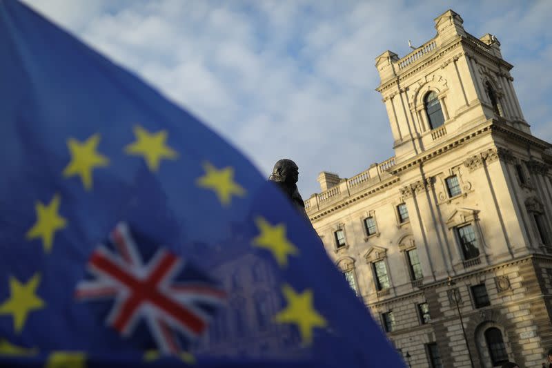 A flag is seen outside the Houses of Parliament near the statue of former Prime Minister Winston Churchill in London