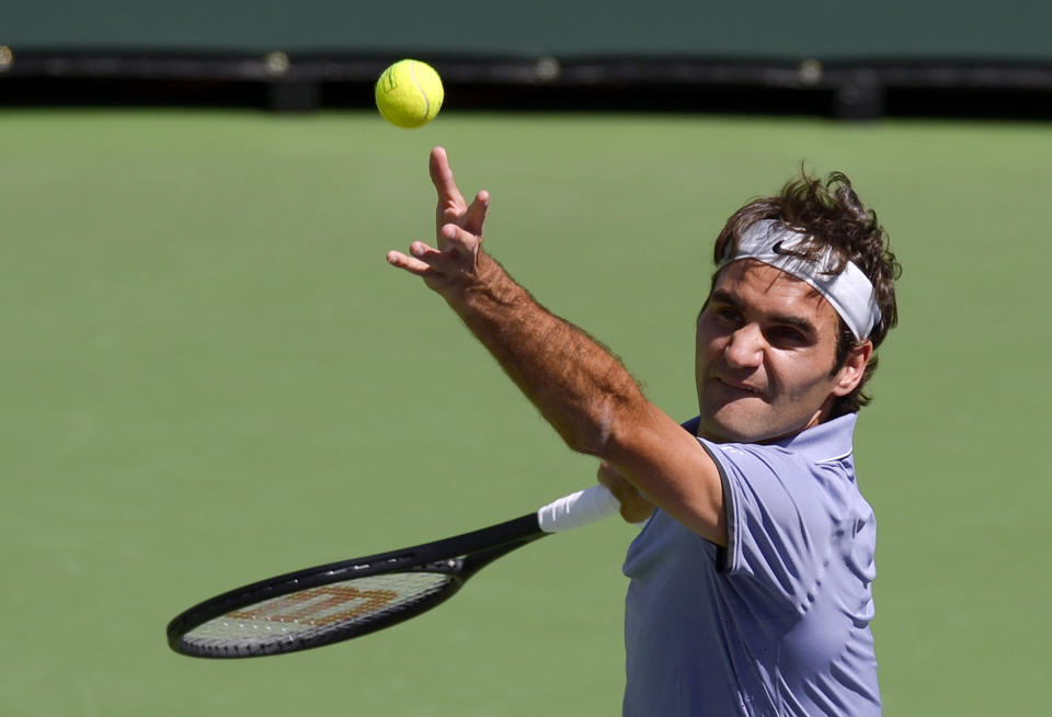 Roger Federer, of Switzerland, serves to Alexandr Dolgopolov, of Ukraine, during their semifinal match at the BNP Paribas Open tennis tournament, Saturday, March 15, 2014, in Indian Wells, Calif. (AP Photo/Mark J. Terrill)