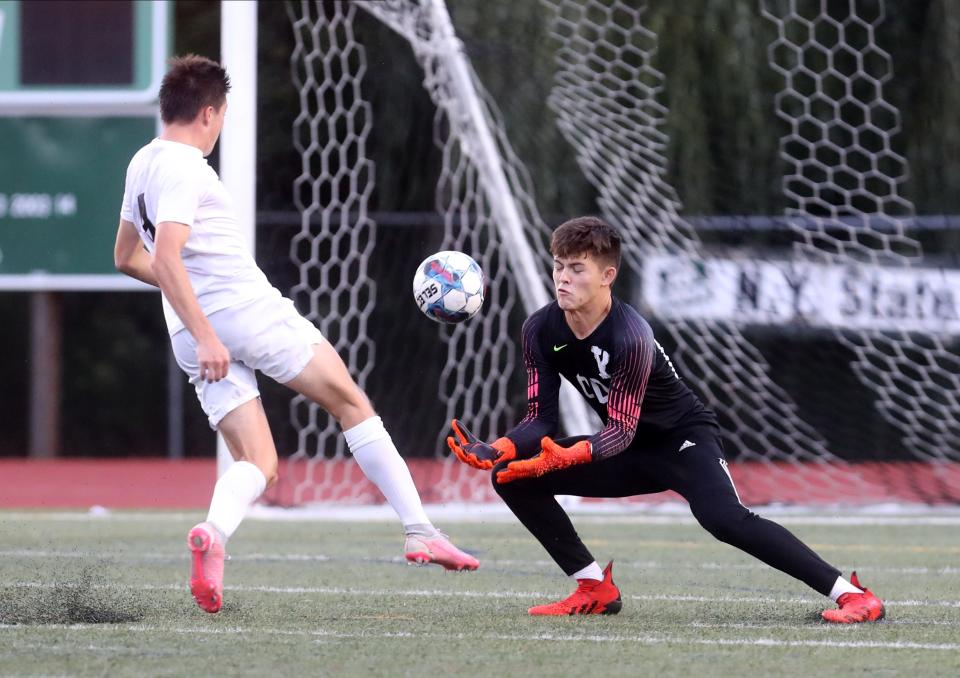 Rye's Tommy Broderick shoots on Yorktown goalie JP Frucco to the ball during a varsity soccer game at Yorktown High School Sept. 12, 2022. Yorktown defeated Rye 4-1.