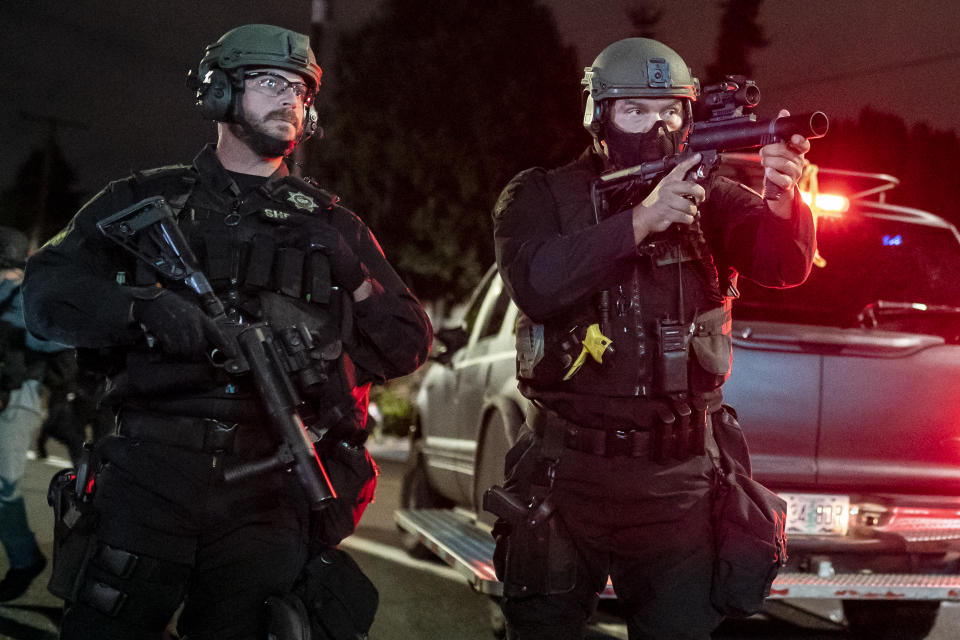A Multnomah County Sheriffs deputy points a less lethal weapon at anti-police protesters near the Portland east police precinct a day after political violence left one person dead on August 30, 2020 in Portland, Oregon. (Nathan Howard/Getty Images)