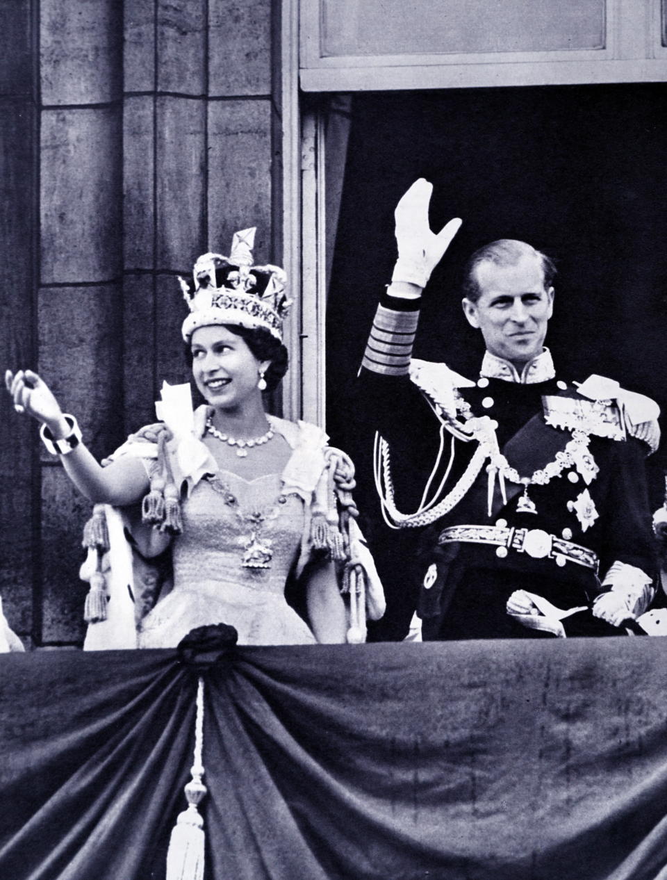 The coronation of Elizabeth II of the United Kingdom, took place on 2 June 1953 at Westminster Abbey, London. Queen Elizabeth II, with the Duke of Edinburgh, at Buckingham Palace shortly after their return from Westminster Abbey. (Photo by: Universal History Archive/Universal Images Group via Getty Images)