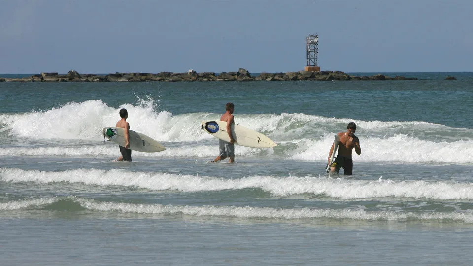 FILE - Surfers hit the waves at New Smyrna Beach in Florida. (Photo by Barbara V. Perez/Orlando Sentinel/Tribune News Service via Getty Images)