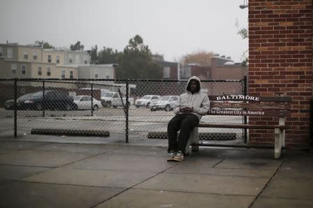 An man sits on a bench near the John Hopkins Hospital in Baltimore, Maryland November 5, 2015. REUTERS/Carlos Barria