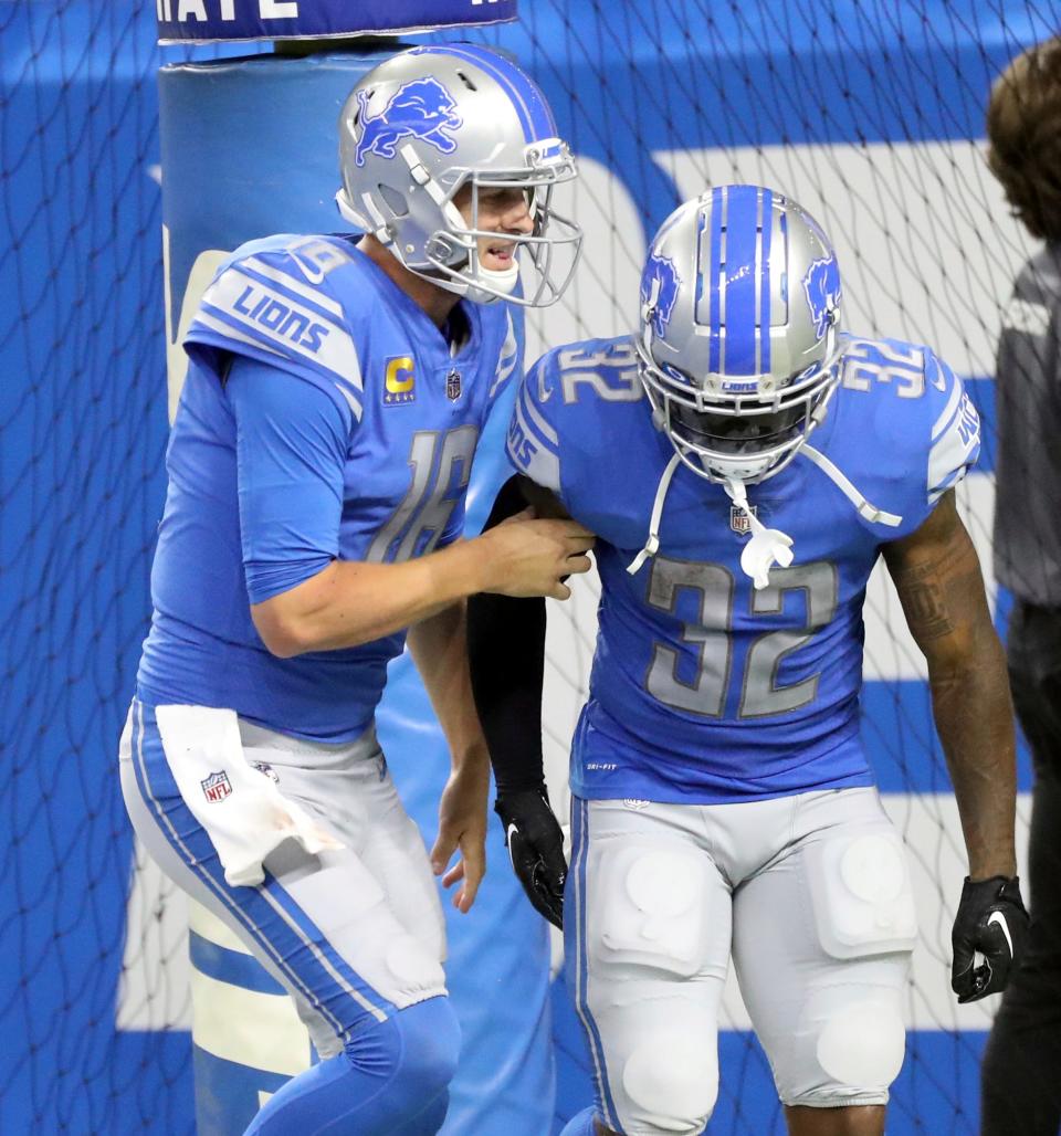 Sep 18, 2022; Detroit, Michigan, USA; Detroit Lions quarterback Jared Goff (16) and Detroit Lions running back D'Andre Swift (32) celebrate after a touchdown against the Washington Commanders during second half action at Ford Field.