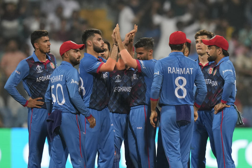 Afghanistan's Naveen-ul-Haq, third left, celebrates with teammates the dismissal of Australia's Mitchell Marsh during the ICC Men's Cricket World Cup match between Australia and Afghanistan in Mumbai, India, Tuesday, Nov. 7, 2023. (AP Photo/Rajanish Kakade)