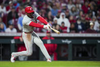 Philadelphia Phillies' Johan Rojas hits an RBI single during the sixth inning of the team's baseball game against the Cincinnati Reds in Cincinnati, Wednesday, April 24, 2024. (AP Photo/Aaron Doster)